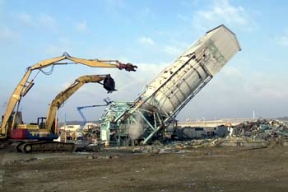 Workers Topple the Bulk Lime Handling Building.
Plants 2 and 3 Decontamination and Demolition Project - Plants 2 and 3, the Ore Refinery Plants, were used to convert feed materials and recycled scrap to high purity uranium trioxide (UO3). Three processes were used during the conversion: digestion, where uranium was converted to soluble uranyl nitrate; extraction, where uranyl nitrate was extracted by a solvent mixture; and denitration, where high purity uranyl nitrate was converted to UO3. The D&D of the plants consists of surface decontamination, building and equipment dismantlement, size reduction of building material and the loading of demolition debris into rolloff boxes for transfer to the On-Site Disposal Facility. 
Keywords: Fernald Closure Project Fernald Green Salt Plant, Feed Materials Production Center, Fernald, Ohio (FEMP)