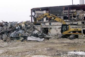 Analytical Lab Decontamination and Demolition Project - An Operating Engineer uses Grapplers to Segregate Demolition Debris that Needs Further Size Reducing from that which can be Immediately Loaded for Transfer to the On-Site Disposal Facility (OSDF).
The Analytical Laboratory housed the analytical, metallugical and chemical process laboratories and was divided into restricted and non-restricted areas. During Fernald's production era the facility was used to verify the uranium product quality. The laboratory used state of the art technology and various chemicals during the preparation and determination of the analytical result. More recently, the laboratory staff processed various samples associated with cleanup. The D&D of the Lab consists of asbestos abatement, building and equipment dismantlement, size reduction of building material and loading for transfer to the On-Site Disposal Facility. 
Keywords: Fernald Closure Project Fernald Green Salt Plant, Feed Materials Production Center, Fernald, Ohio (FEMP)