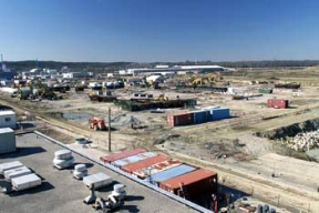 Plants 2, 3 and 8 After Demolition.
Plant 8, the Scrap Recovery Plant, recycled residues and scrap from the uranium production process. Ores, concentrates and process residues were roosted to oxidize the impurities and then filtered. The filtered material was converted to free flowing powder and transferred to Plant 2 for further processing. The D&D of the plants consists of surface decontamination, building and equipment dismantlement, size reduction of building material and the loading of demolition debris into rolloff boxes for transfer on the On-Site Disposal Facility. 
Keywords: Fernald Closure Project Fernald Green Salt Plant, Feed Materials Production Center, Fernald, Ohio (FEMP)