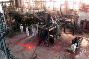 Workers Remove Process Piping in the Pilot Plant as Part of the Demolition Process.
The Pilot Plant was the first plant to go on line at Fernald. The plant served as an operating prototype for all phases of the uranium metal production process and a training area for new operators. Later, the plant's main function became the conversion of uranium hexaflouride (UF6) to uranium tetraflouride (UF4), called green salt, for use in the metal production process. Workers also purified thorium and converted thorium nitrate to thoria gel oxides in the plant. The D&D of the plants consists of surface decontamination, building and equipment dismantlement, size reduction of building material and the loading of demolition debris into rolloff boxes for transfer to the On-Site Disposal Facility. 
Keywords: Fernald Closure Project Fernald Green Salt Plant, Feed Materials Production Center, Fernald, Ohio (FEMP)