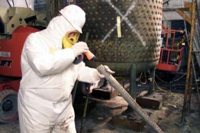 A Member of the Waste Acceptance Organization Inspects a Section of Pipe Before Allowing Workers to Move it to the On-Site Disposal Facility (OSDF).
The Pilot Plant was the first plant to go on line at Fernald. The plant served as an operating prototype for all phases of the uranium metal production process and a training area for new operators. Later, the plant's main function became the conversion of uranium hexaflouride (UF6) to uranium tetraflouride (UF4), called green salt, for use in the metal production process. Workers also purified thorium and converted thorium nitrate to thoria gel oxides in the plant. The D&D of the plants consists of surface decontamination, building and equipment dismantlement, size reduction of building material and the loading of demolition debris into rolloff boxes for transfer to the On-Site Disposal Facility. 
Keywords: Fernald Closure Project Fernald Green Salt Plant, Feed Materials Production Center, Fernald, Ohio (FEMP)