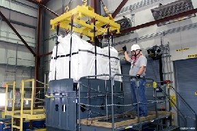 Fernald Silo 3 Project - Shipping Preparations
Workers will remove 5,100 cubic yards of low-level cold metal oxide waste from Silo 3. Waste from the production process was placed in the silo between 1952 and 1957. Workers will use pneumatic and mechanical retrieval systems to remove the waste from the silo and package it in soft-sided containers for off site shipment. The waste will be treated only as required to meet commercially permitted facility's waste acceptance criteria. 
Keywords: Fernald Closure Project Fernald Green Salt Plant, Feed Materials Production Center, Fernald, Ohio (FEMP)