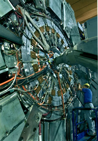 TECHNICIAN AT THE B FACTORY'S HUGE BABAR DETECTOR SYSTEM AT THE STANFORD LINEAR ACCELERATOR CENTER.
BABAR IS A 1200 TON DETECTOR SYSTEM THAT CAN SIFT THROUGH THE 238 MILLION BEAM CROSSINGS THAT WILL OCCUR EVERY SECOND IN THE B FACTORY AND ANALYZE THE THREE TO FOUR EVENTS THAT CAN BEST BE STUDIED FOR CP VIOLATION (CHARGE-CONJUGATION/PARITY). THE BABAR DETECTOR SYSTEM AFFORDS SCIENTISTS FORM LBNL, LLNL AND SLAC THE OPPORTUNITY TO STUDY THE DIFFERENCE BETWEEN MATTER AND ANTIMATTER AND PLAYS A LARGE ROLE IN THE UNDERSTANDING OF NATURE AND MATTER. 
Keywords: Stanford Linear Accelerator Center (SLAC)