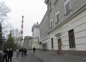 Seversk visitors walking past brick building and stack